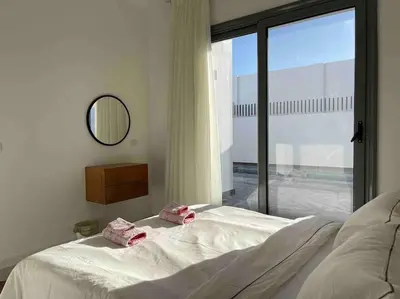 a bedroom with a bed and a large window at 3bd with a private heated pool in Sholan 2 ElGouna in Hurghada