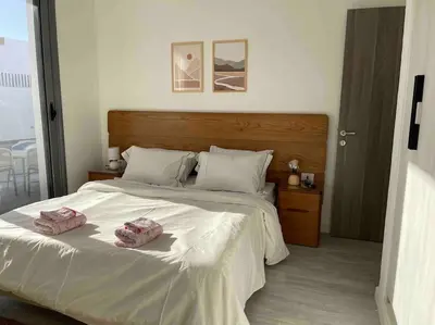 a bedroom with a large bed with two towels on it at 3bd with a private heated pool in Sholan 2 ElGouna in Hurghada