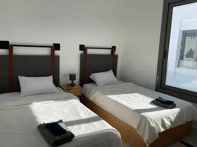 two beds sitting next to each other in a room at 2 bedroom with a private heated pool in Sholan2 in Hurghada