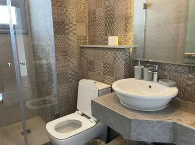 a bathroom with a toilet and a sink and a shower at 2 bedroom with a private heated pool in Sholan2 in Hurghada