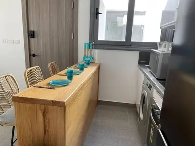 a kitchen with a counter with blue dishes on it at 2 bedroom with a private heated pool in Sholan2 in Hurghada