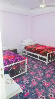two beds in a room with a carpet at Luxor Nile palace in Luxor