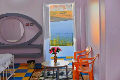 a room with a table and two chairs and a window at Luxor Nile palace in Luxor