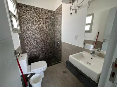 a bathroom with a white toilet and a sink at Ground floor one bedroom overlooking the pool. in Hurghada