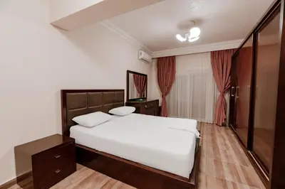 a bedroom with a white bed and a mirror at Luxury private villa with pool in Hurghada