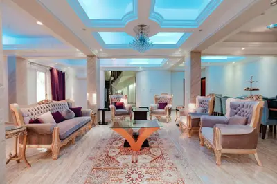 a waiting room with couches and chairs and a table at Luxury private villa with pool in Hurghada
