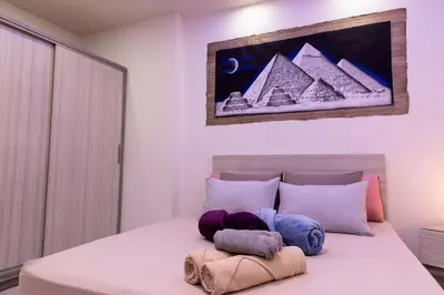 a bedroom with a bed with pyramids on it at F&M Home Egypt - Apartment Hurghada in Hurghada