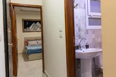 a bathroom with a sink and a mirror at F&M Home Egypt - Apartment Hurghada in Hurghada