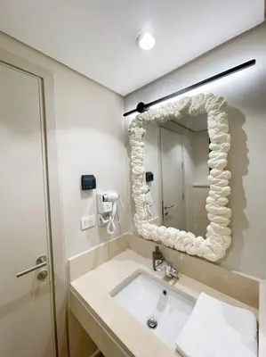 a bathroom with a sink and a mirror at Snazzy 1BDR w Rooftop Mangroovy Free Pool & Beach Access in Hurghada