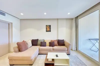 a living room with a couch and a table at Panoramic & Cushy 3BDR Mangroovy Free pool & Beach Access in Hurghada