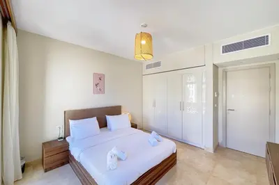 a bedroom with a bed with towels on it at Panoramic & Cushy 3BDR Mangroovy Free pool & Beach Access in Hurghada
