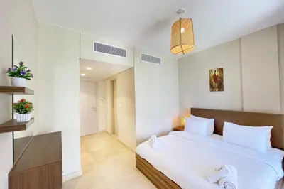 a bedroom with a large white bed in a room at Panoramic & Cushy 3BDR Mangroovy Free pool & Beach Access in Hurghada