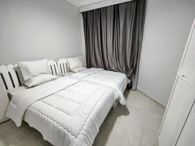 a white bed in a room with a window at Sea Dreams @ Hurghada Dreams in Hurghada