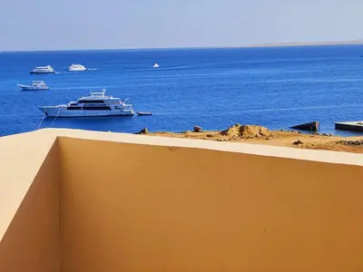 a boat in the ocean with boats in the water at Sea Dreams @ Hurghada Dreams in Hurghada