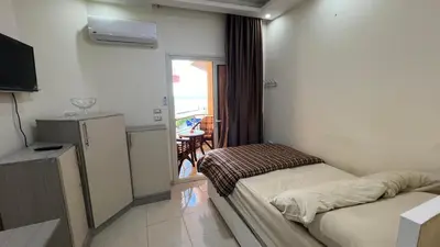 a hotel room with two beds and a balcony at Casablanca beach resort, first line with private beach and swimming pools, in Hurghada