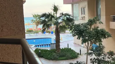 a view of a pool and palm trees from a building at Casablanca beach resort, first line with private beach and swimming pools, in Hurghada