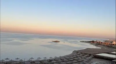 an aerial view of a beach with umbrellas and the ocean at Casablanca beach resort, first line with private beach and swimming pools, in Hurghada
