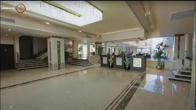a lobby with a swimming pool in a building at Casablanca beach resort, first line with private beach and swimming pools, in Hurghada