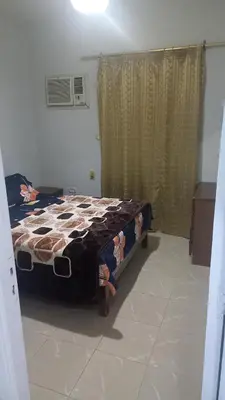 a bedroom with a bed with a comforter on it at New ikea flat 2 in Hurghada