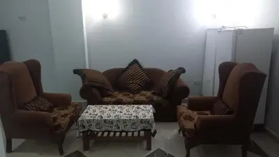 a living room with a couch and two chairs and a table at New ikea flat 2 in Hurghada