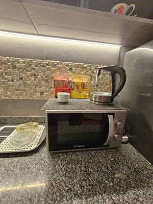 a microwave sitting on a kitchen counter with a coffee maker at Hurghada - Apartment Blue Lagoon in Hurghada