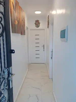 a hallway with a white door and a tile floor at White House in Aswan