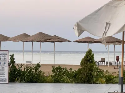 a group of umbrellas on a beach with the ocean at شقة احلامك علي البحر in Hurghada