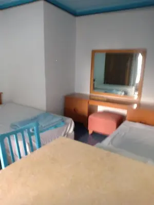 a room with two beds and a desk and a mirror at A two-room chalet in the village of Lale Land, Mirage Bay, Ecopark in Hurghada