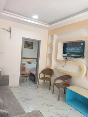 a living room with a tv on a wall at A two-room chalet in the village of Lale Land, Mirage Bay, Ecopark in Hurghada