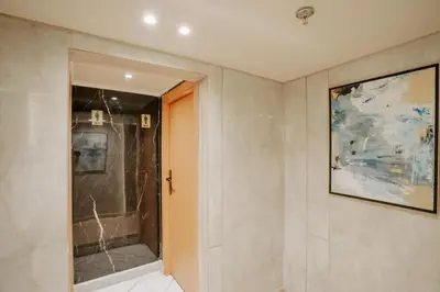 a bathroom with a shower and a painting on the wall at Cleopatra Nile Cruise From Luxor 3&4 Nights Every Saturday and Monday, Thursday in Luxor