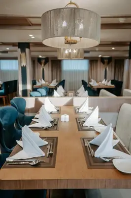 a dining room with a table with white napkins on it at Cleopatra Nile Cruise From Luxor 3&4 Nights Every Saturday and Monday, Thursday in Luxor
