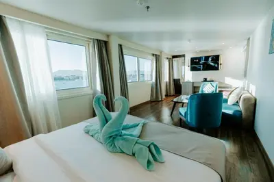 a room with a bed with a stuffed animal on it at Cleopatra Nile Cruise From Luxor 3&4 Nights Every Saturday and Monday, Thursday in Luxor