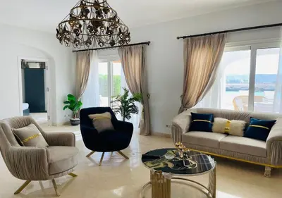 a living room with a couch and chairs and a chandelier at Unique 6 Bedrooms Villa 38 at White Villas El-Gouna in Hurghada