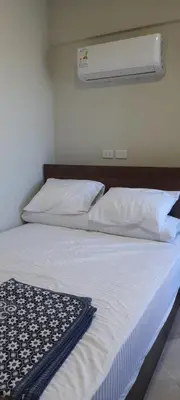 a bedroom with a bed with white sheets and pillows at Princess resort unit number 260A Markos in Hurghada