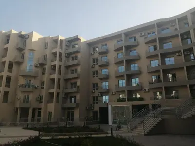 a large apartment building with stairs in front of it at Princess resort unit number 260A Markos in Hurghada