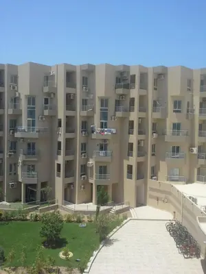 a large apartment building with balconies and a yard at Princess resort unit number 260A Markos in Hurghada