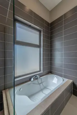 a bath tub in a bathroom with a window at Ascot Bay, Premium 5BR Lagoon Beach House & Pool in Tawila, El Gouna in Hurghada