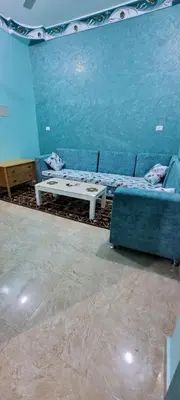 a living room with a couch and a table at Ahmed House in Safaga