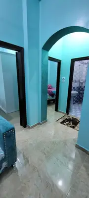 a room with blue walls and an arched doorway at Ahmed House in Safaga