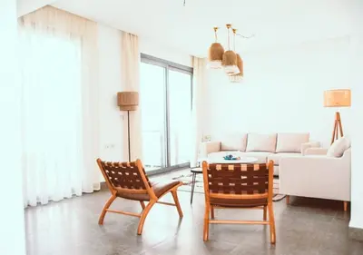 a living room with a couch and a table and chairs at Peaceful Villa 3BR at Sholan with Private Heated Pool in Hurghada