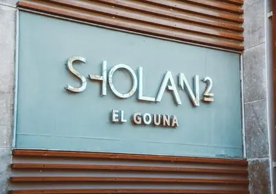 a sign for a store on the side of a building at Peaceful Villa 3BR at Sholan with Private Heated Pool in Hurghada