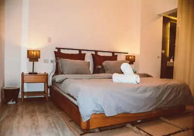a bedroom with a large bed with a stuffed animal on it at Peaceful Villa 3BR at Sholan with Private Heated Pool in Hurghada