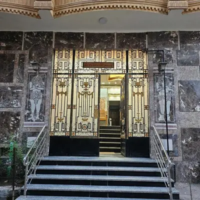 an entrance to a building with gold doors and stairs at Susan's Guest House and Tours in Luxor
