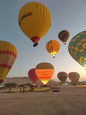 a group of hot air balloons in the sky at Susan's Guest House and Tours in Luxor