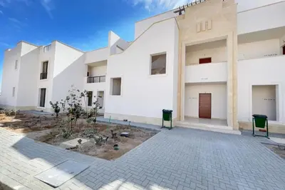 an exterior view of a white building at Homelike & Sunny 1 BDR Cyan El Gouna in Hurghada