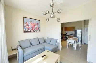 a living room with a blue couch and a table at Homelike & Sunny 1 BDR Cyan El Gouna in Hurghada