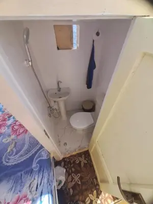 a small bathroom with a toilet and a sink at NUBIAN MONALIZA guest house in Aswan