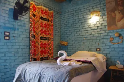 a swan sitting on a bed in a room at Bedouin Lodge Luxor in Luxor