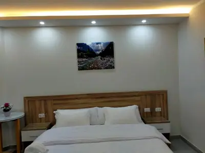 a bedroom with a bed with a picture on the wall at Happy Home in Hurghada