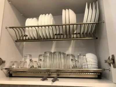 a shelf with glass jars and plates on it at Beautiful apartment near sea 1+1 Dream Beach in Hurghada